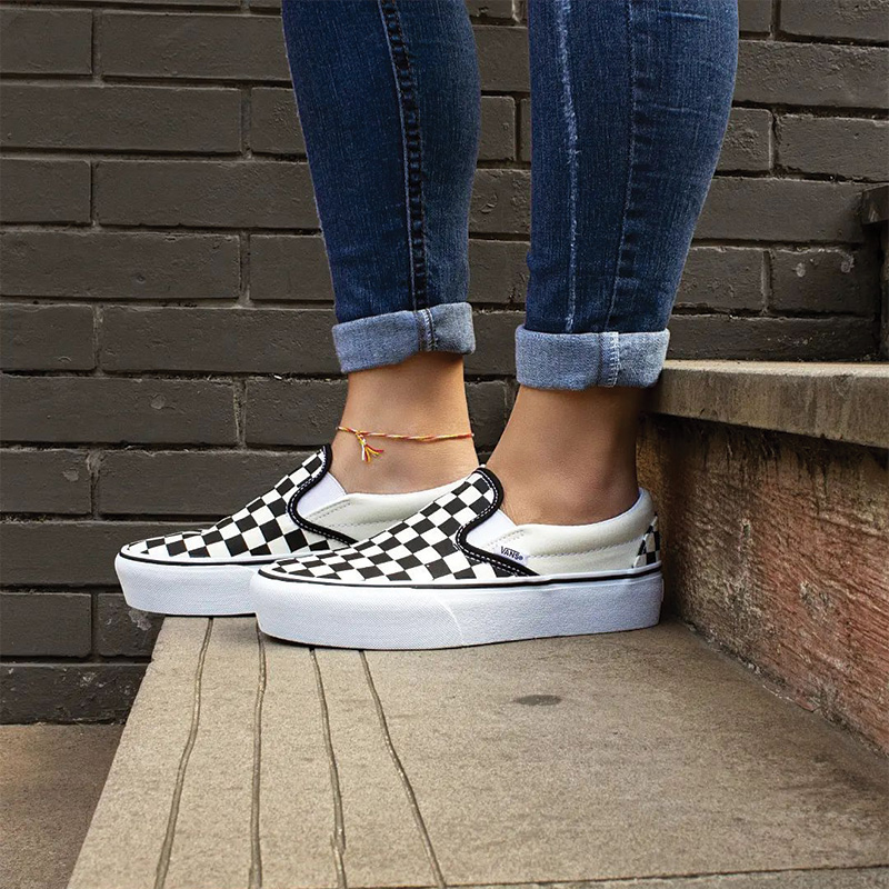 checkered vans slip ons on feet